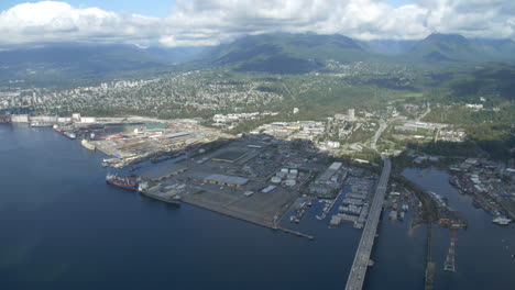 North-Vancouver-and-Lonsdale-ship-yards-from-Helicopter-looking-north-towards-the-second-narrows-bridge,-grouse-mountain-and-Seymour-Mountain-in-British-Columbia