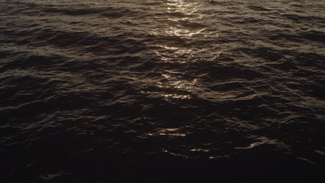wide shot and tilt up from the water reflection to the sunset in buenaventura at colombia's pacific coast