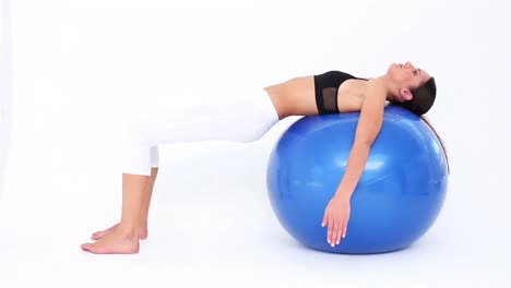 fit model doing pelvic lifts on blue exercise ball