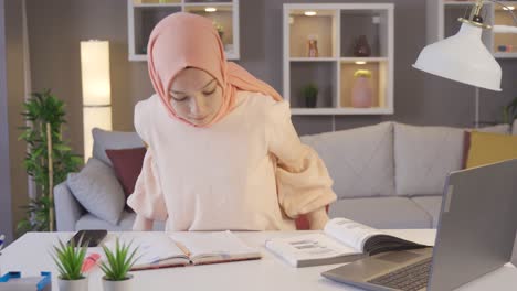 Young-pensive-confused-arab-woman-in-hijab-working-on-laptop.