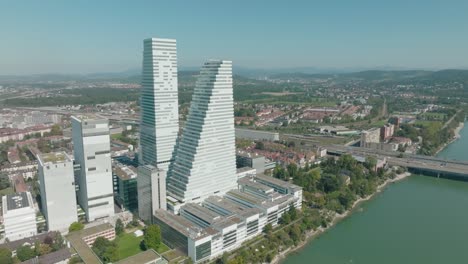 aerial flies over rhine river in basel with the two roche towers and kleinbasel in frame