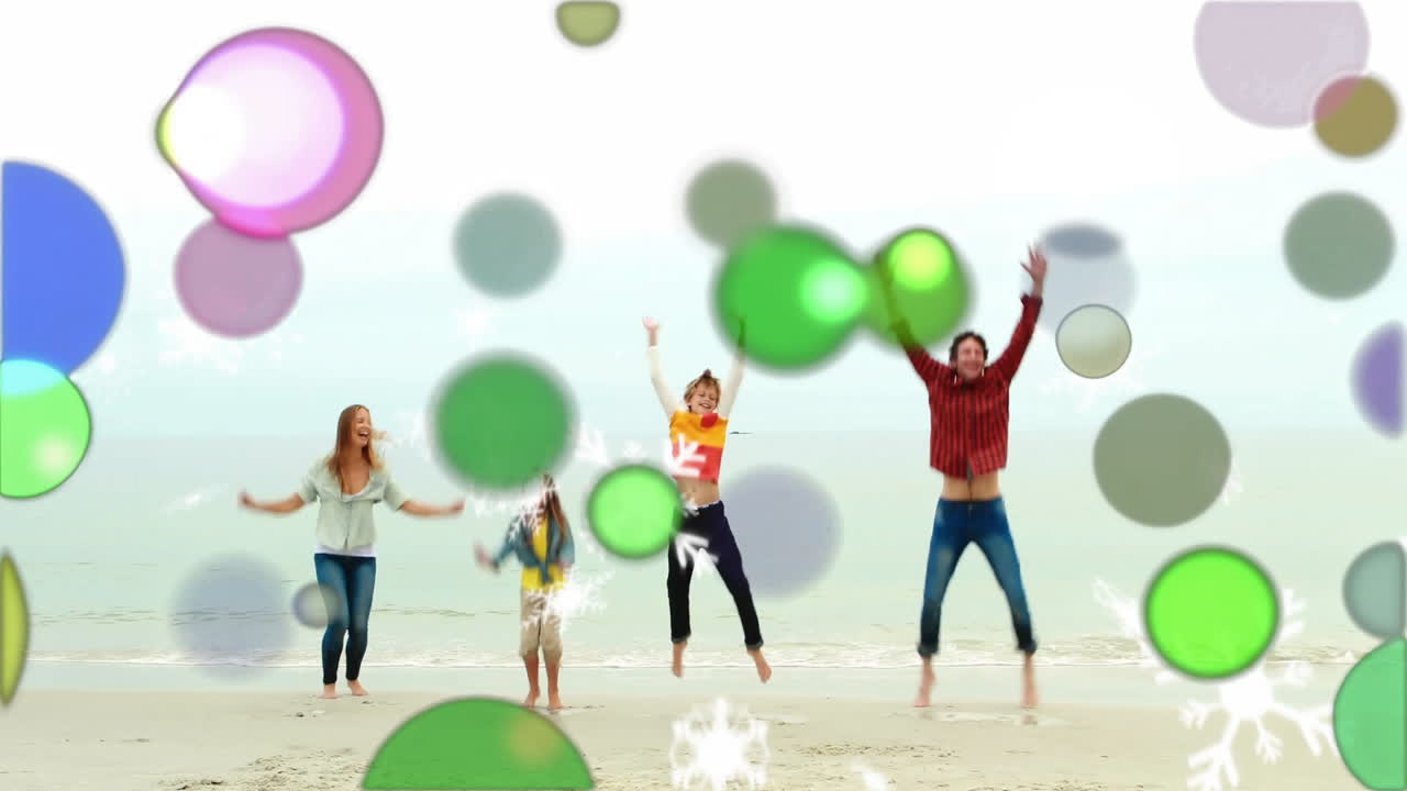 Family jumping on beach with colorful bubbles and snowflakes animation overlay