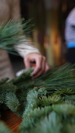 making a christmas wreath with pine branches