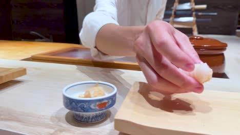 chef skillfully crafts nigiri sushi in bangkok