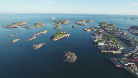 aerial drone perspective revealing picturesque henningsvar fishing village nestled among rocky lofoten islands with colorful buildings and scenic coastal landscape