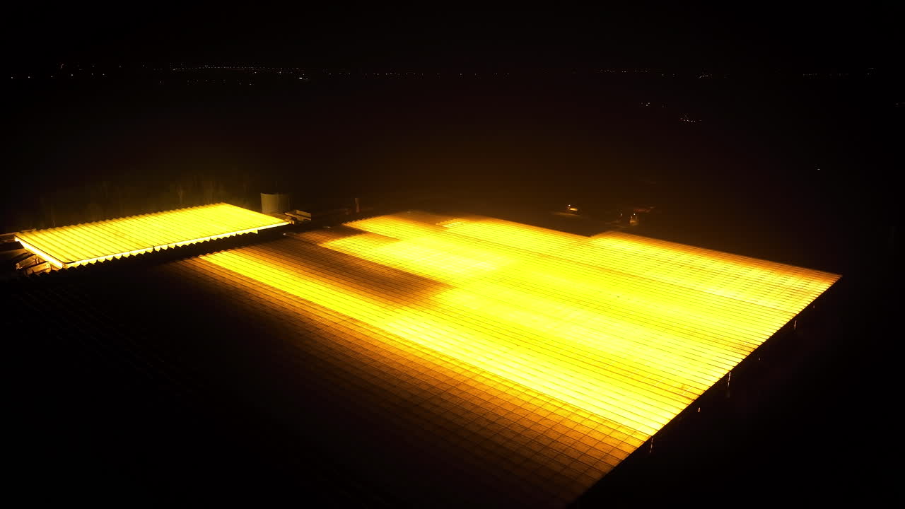 Illuminated Greenhouse Facility at Night