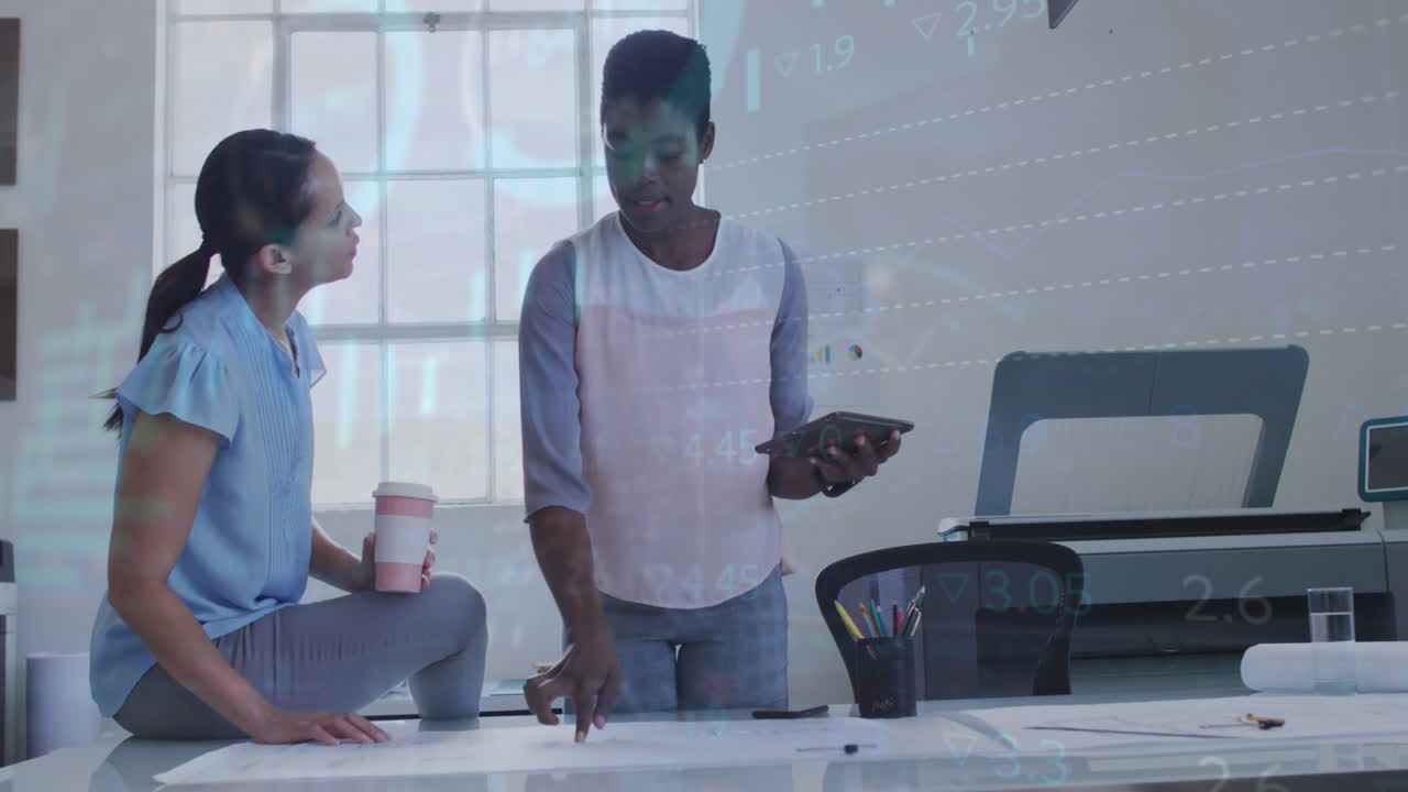Animation of data processing over two diverse women discussing over a plan at office