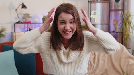 excited woman girl surprised shocked by sudden victory good win news celebrating wow reaction