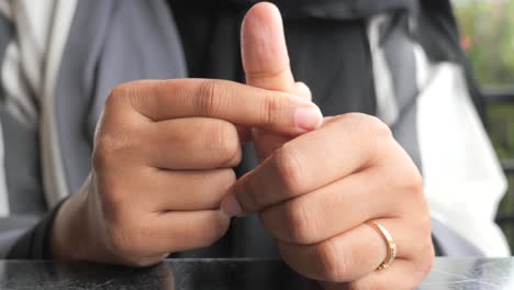 woman wearing a ring, showing her fingers and hand