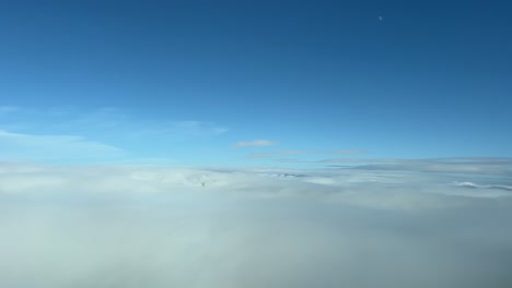 nice view from a jet cockpit while flying over a layer of stratus clouds during the descent