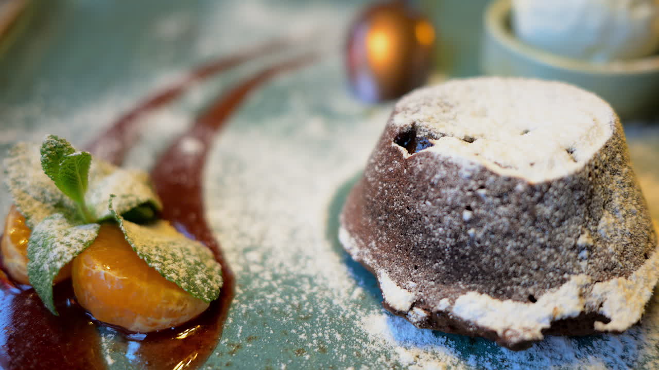 Chocolate lava cake with ice cream and orange decoration in a restaurant