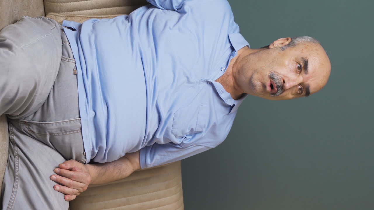 el video vertical del anciano viendo la televisión le gusta y aprueba las noticias.