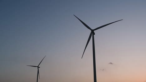 Wind-Turbines-Silhouette-against-the-Blue-sky-during-Sunset,-clean-alternative-energy-in-Thailand-and-mainland-Southeast-Asia