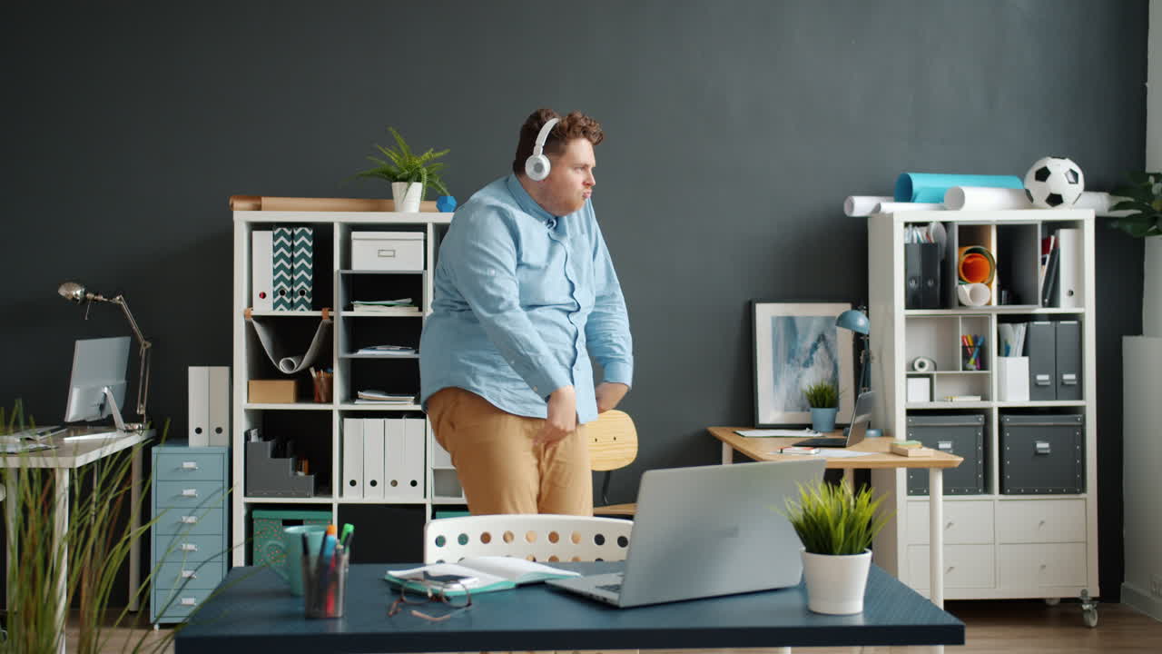 Man Dancing in Office During Video Call