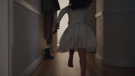 beautiful little girl runningthrough house jumping on bed holding teddy bear having fun child in playful mood enjoying weekend morning at home