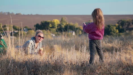 mother and daughter enjoying a picnic in the countryside