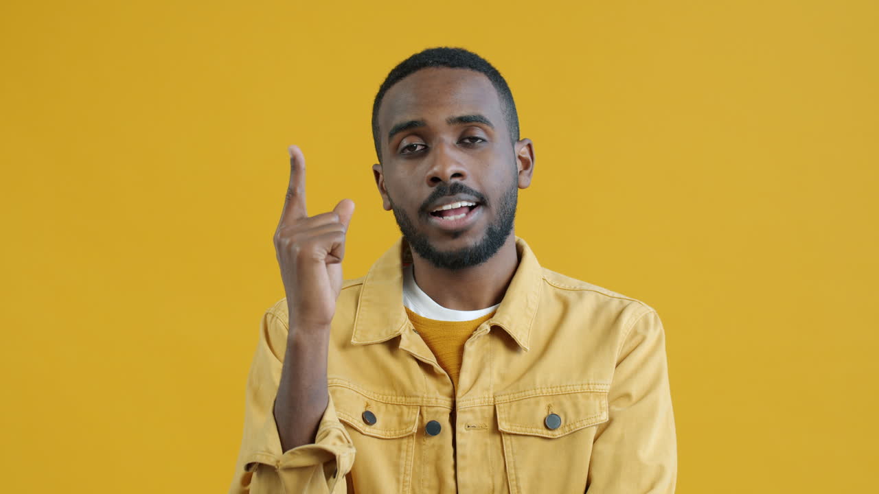 Man Posing in Front of a Yellow Background