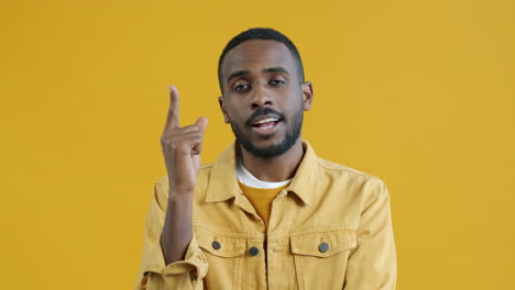 man posing in front of a yellow background