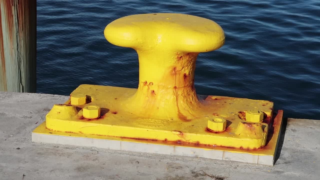 A yellow bollard at an old seaport