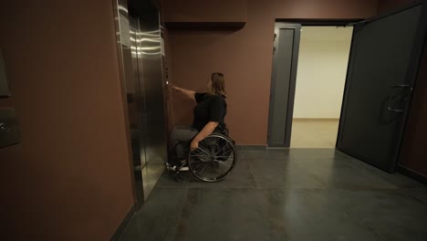 a woman in a wheelchair waits in front of an elevator in a building, emphasizing accessibility and mobility in public infrastructure. the image conveys independence and inclusive design for all users.