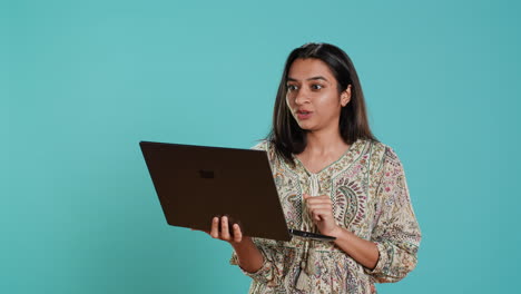 Irked-woman-fighting-with-coworkers-during-videocall-on-laptop