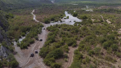 Off-road-four-wheel-drive-vehicles-driving-through-river-bed