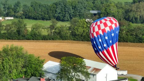 Globo-Aerostático-Con-Una-Bandera-Americana-Desinflándose-Después-De-Aterrizar-En-Un-Campo-Rural-En-Estados-Unidos