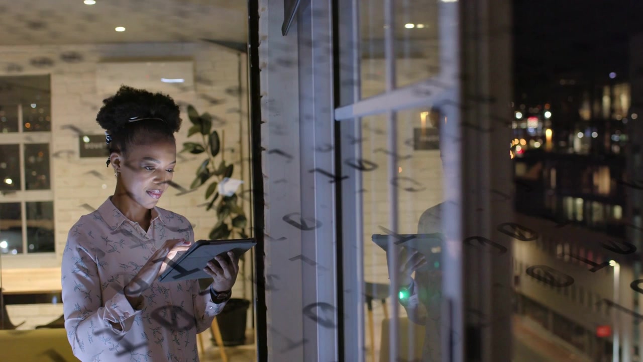 Woman at window tapping tablet, checking tech dashboard while reflection and city lights glowing