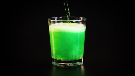 green drink poured, fizzing in a glass