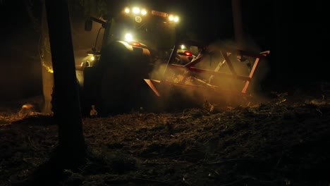 forest mulcher processes tree remains after bark beetle infestation at night