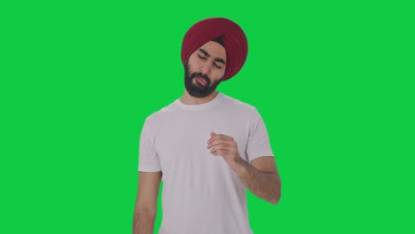 sick sikh indian man suffering from neck pain green screen