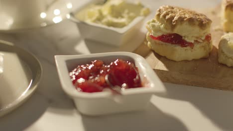 close up of traditional british afternoon tea with scones cream and jam 2