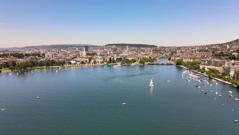 Drone-flyover-shot-over-Lake-Zürich-in-Switzerland-towards-the-city-of-Zürich