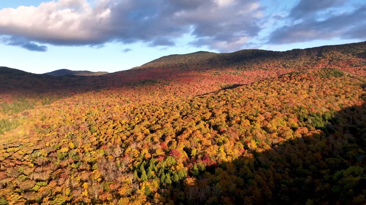 aerial pullout from vibrant leaf color near stowe vermont in new england in fall