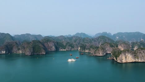 aerial drone shot over ha long bay, blue sea and limestone islands of lan ha bay