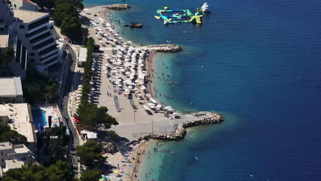 Telephoto-drone-shot-of-the-coast-of-the-Podgora-town,-in-Makarska-riviera,-Croatia