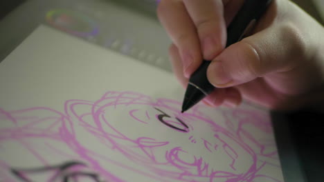 a caucasian woman's hand draws a digital illustration on a tablet in slow motion