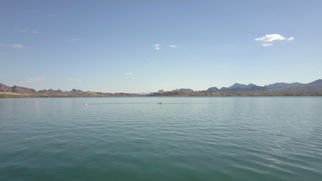 Kayakers In Lake With Mountains 4k