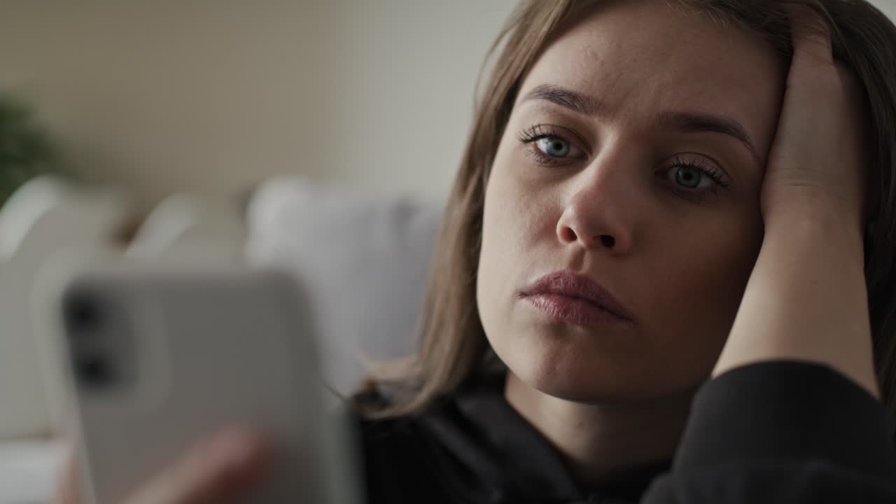 Caucasian using mobile phone with mental problem.