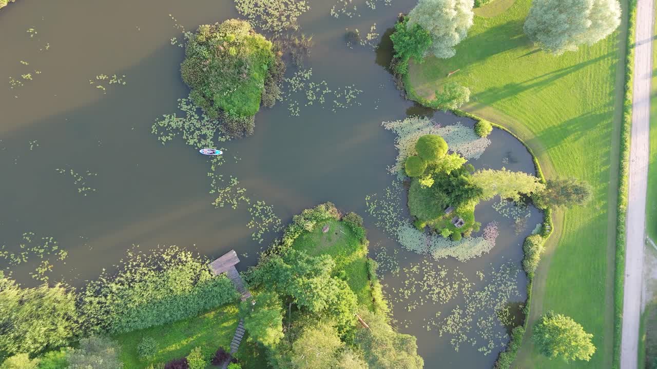 Flying Above Young Woman Stand Up Paddling on Sup Board on Pond in Summer