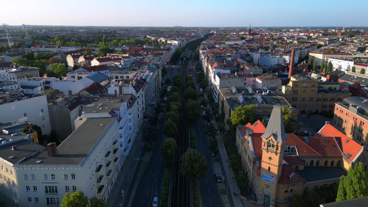 Elevated train navigating through a residential area in berlin, showcasing the city's urban transportation system. Perfect aerial view flight overflight flyover drone