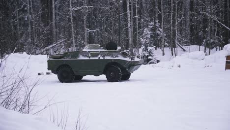 military vehicle in snowy forest environment