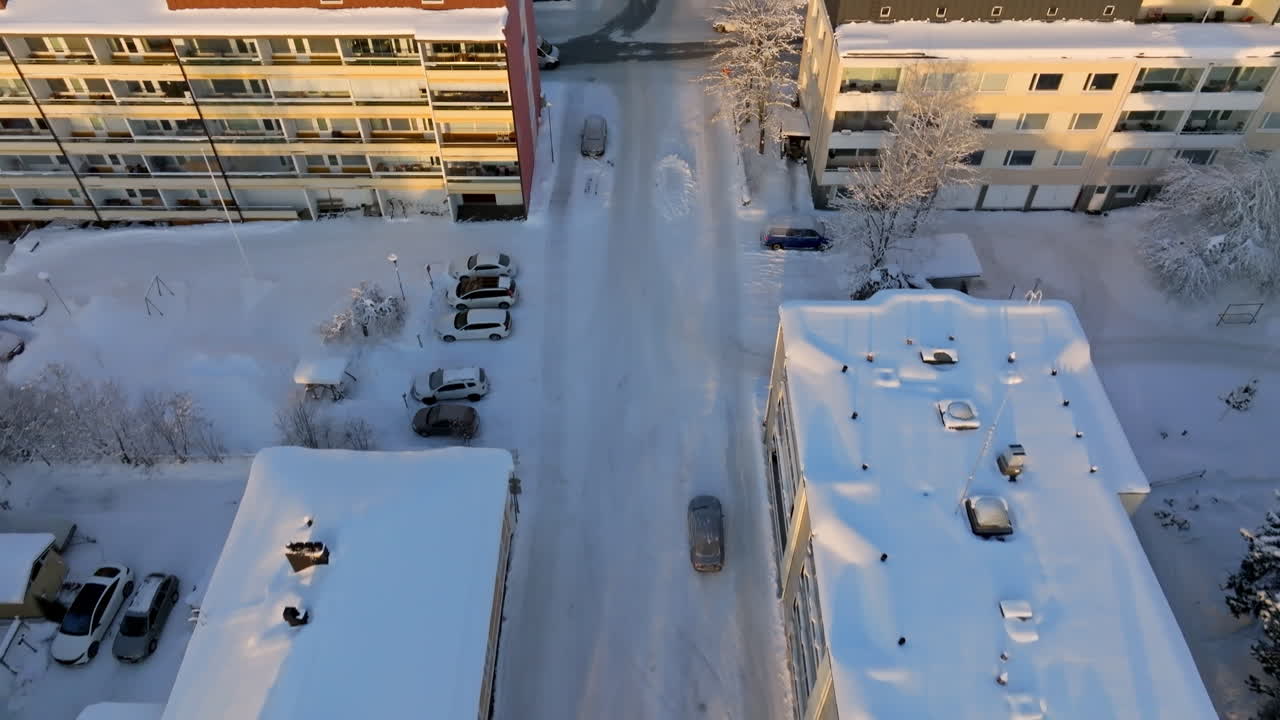 Aerial view tilting of snowy downtown Kuopio, sunny, winter sunset in Finland
