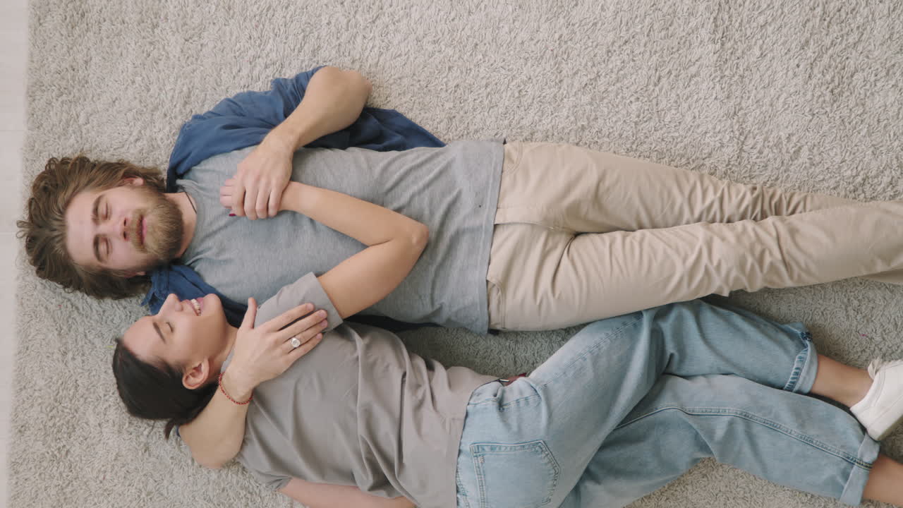 Couple laying on carpet