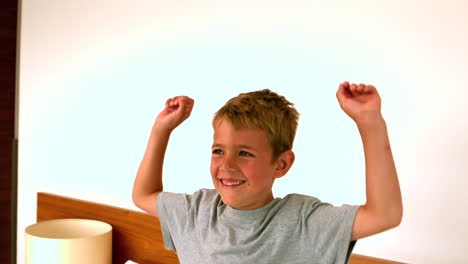 little boy jumping on the bed