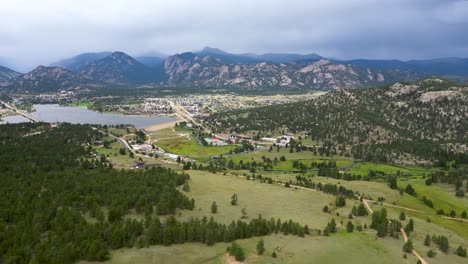 view from above the countryside green landscape with background of rocky mountains in denver, colorado, usa