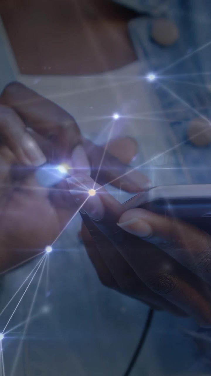 Tapping woman's hands in denim jacket swiping phone at home, cable connecting overlay glowing