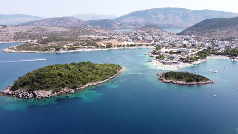 cityscape, coastline and small beach at ksamil islands, albania - reversing aerial