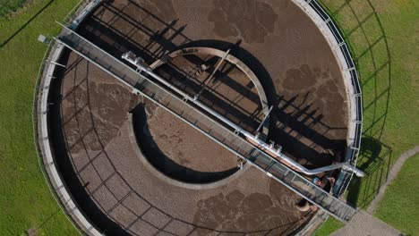 aerial top down view of wastewater treatment plant with green grass