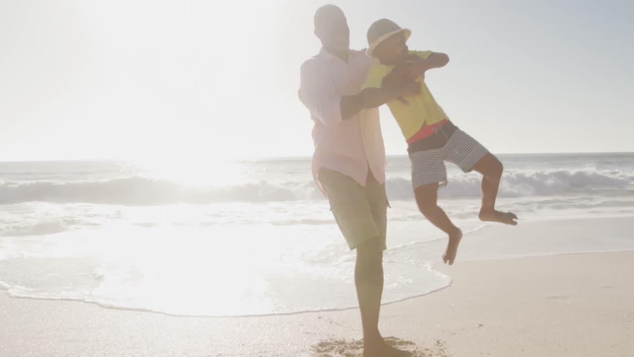 웃는 노인 아프리카계 미국인 부부 가  ⁇ 빛 해변 에서 손자 들 과 함께 놀고 있다
